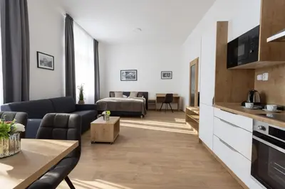 a living room with a couch and a table at Residence Morris Mladá Boleslav in Mladá Boleslav