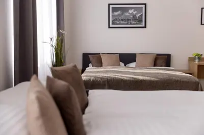 two beds sitting next to each other in a bedroom at Residence Morris Mladá Boleslav in Mladá Boleslav