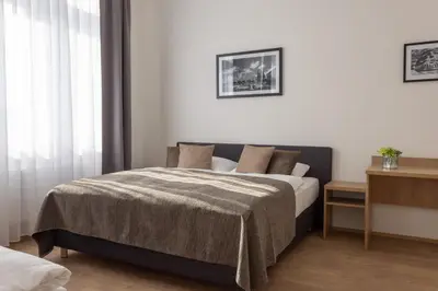 a bedroom with a bed with a blanket at Residence Morris Mladá Boleslav in Mladá Boleslav