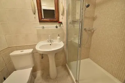 a bathroom with a toilet and a sink and a shower at Chateau Loucen Garden Retreat in Loučeň