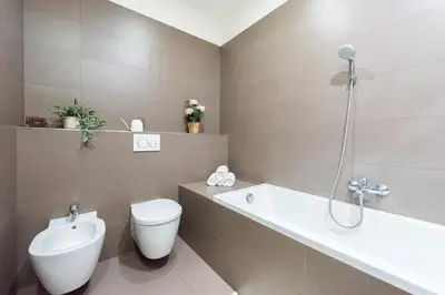 a bathroom with a toilet and a tub and a sink at Spacious 3-bedrooms apartment near Karlin Square in Prague