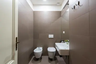a bathroom with a toilet and a sink at Spacious 3-bedrooms apartment near Karlin Square in Prague