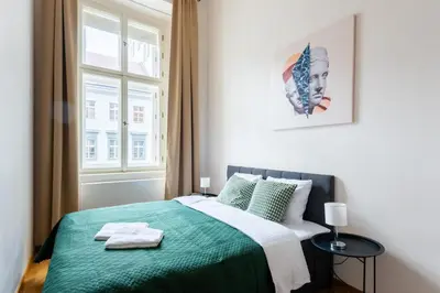 a bedroom with a green bed with a window at Spacious 3-bedrooms apartment near Karlin Square in Prague