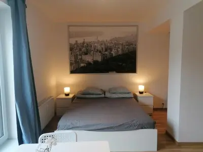 a bedroom with a bed and a painting on the wall at Brand new studio apartment # 45 with free parking in the city center in Prague
