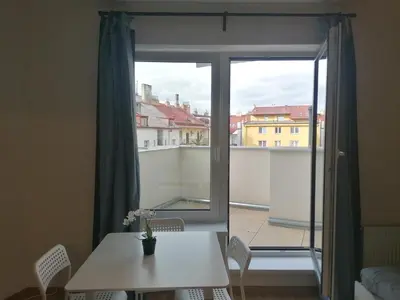 a room with a table and a window with a view at Brand new studio apartment # 45 with free parking in the city center in Prague