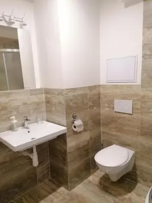 a bathroom with a sink and a toilet at Brand new studio apartment # 45 with free parking in the city center in Prague
