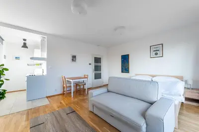 a living room with a couch and a table at Sunny Safron apartment in Prague