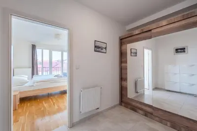 a large mirror in a room with a bedroom at Sunny Safron apartment in Prague