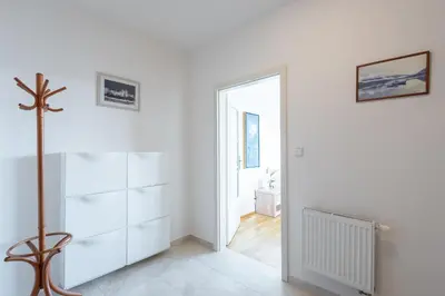 a room with white walls and a pivot door at Sunny Safron apartment in Prague