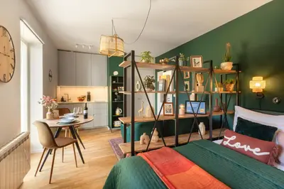 a bedroom with a bed and a table in a room at Prague Bohemian Rhapsody Suites in Prague