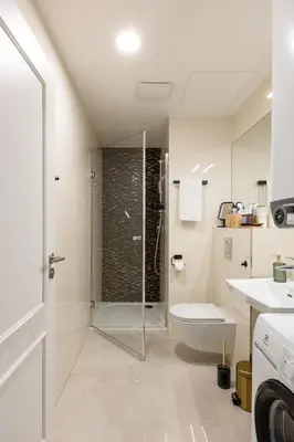 a bathroom with a shower and a toilet and a sink at Prague Bohemian Rhapsody Suites in Prague