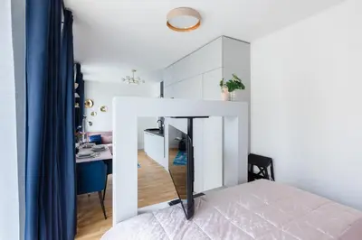 a bedroom with a bed and a desk in a room at Prague Bohemian Rhapsody Suites in Prague