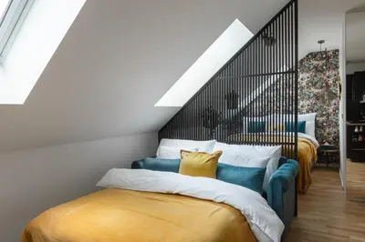 a bedroom with two beds and a staircase at Prague Bohemian Rhapsody Suites in Prague