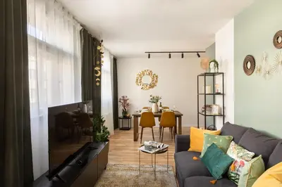 a living room with a couch and a table at Prague Bohemian Rhapsody Suites in Prague
