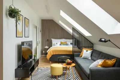 a living room with a bed and a couch at Prague Bohemian Rhapsody Suites in Prague