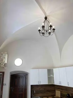 a chandelier hanging from a ceiling in a kitchen at Studio in gothic house, 50m to the Old Town Square in Prague