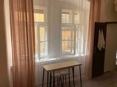 a small table in a room with a window at Studio in gothic house, 50m to the Old Town Square in Prague