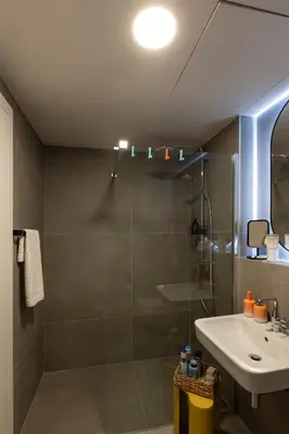 a bathroom with a glass shower and a sink at Urban Chic Residences in Prague