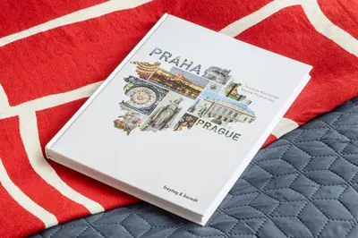 a book sitting on top of a red blanket at Urban Chic Residences in Prague