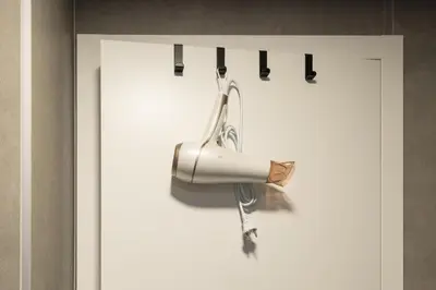 a white door with a hair dryer hanging from it at Urban Chic Residences in Prague