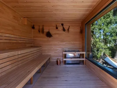 an empty sauna with a bench and a window at Resort po.spolu in Mokrovraty