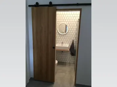 a bathroom with a sink and a toilet and a mirror at Stylish apartment 5 mins from the Charles Bridge in Prague
