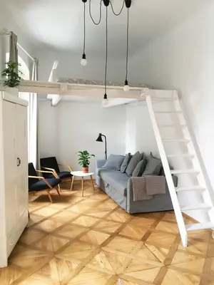 a living room with a couch and a loft bed at Stylish apartment 5 mins from the Charles Bridge in Prague