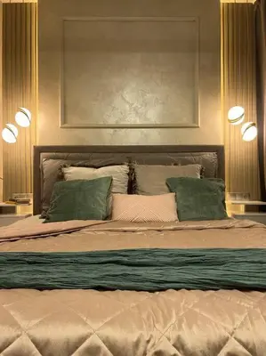 a bedroom with a large bed with two green pillows at Luxury Pearl with Parking place in Holešovice in Prague