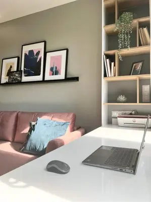 a laptop sitting on a white table in a living room at Luxury Pearl with Parking place in Holešovice in Prague