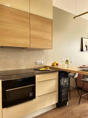 a kitchen with a counter and a table with wine glasses at Luxury Pearl with Parking place in Holešovice in Prague
