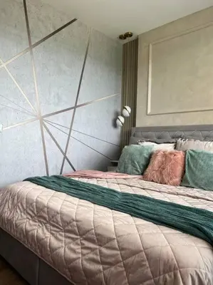 a bedroom with a large bed with colorful pillows on it at Luxury Pearl with Parking place in Holešovice in Prague