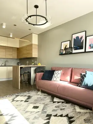 a living room with a couch and a kitchen at Luxury Pearl with Parking place in Holešovice in Prague