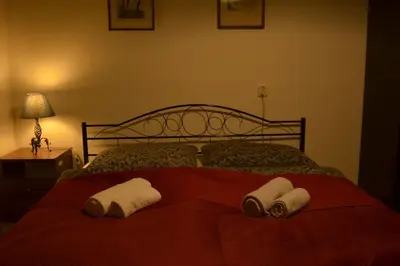 a bedroom with a bed with two towels on it at Retro Apartment Praha in Prague