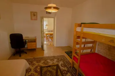 a bedroom with a bunk bed and a desk at Retro Apartment Praha in Prague