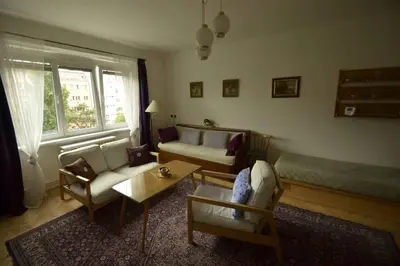 a living room with a couch and a table at Retro Apartment Praha in Prague