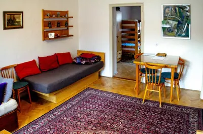 a living room with a couch and a table at Retro Apartment Praha in Prague