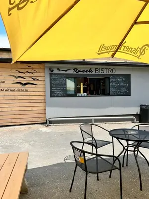 a table and chairs in front of a restaurant at Penzion Racek in Tuchlovice