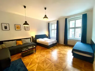 a living room with a couch and a bed at Katerina's Downtown Apartments in Prague