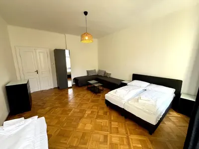a bedroom with a bed and a living room at Katerina's Downtown Apartments in Prague