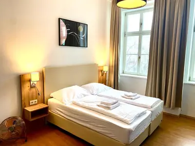 a bedroom with a bed with two towels on it at Katerina's Downtown Apartments in Prague