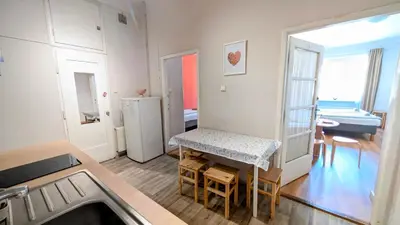 a kitchen with a table and a dining room at Flat in Zizkov -403- in Prague