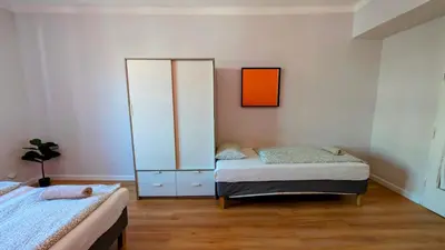 a bedroom with two beds and a cabinet at Flat in Zizkov -403- in Prague