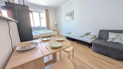 a living room with a table and a couch at Flat in Zizkov -403- in Prague