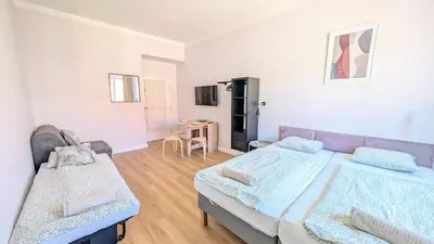 a large bedroom with two beds and a table at Flat in Zizkov -403- in Prague