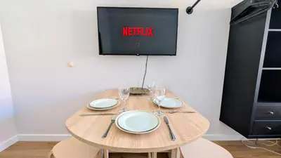 a wooden table with plates and wine glasses on it at Flat in Zizkov -403- in Prague