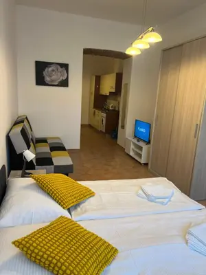 a room with two beds and a living room at Residence Ai Due Mondi in Prague