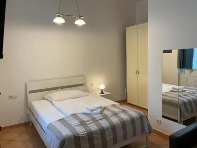 a small bedroom with a bed and a mirror at Residence Ai Due Mondi in Prague