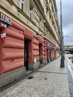 a red building on the side of a street at Residence Ai Due Mondi in Prague