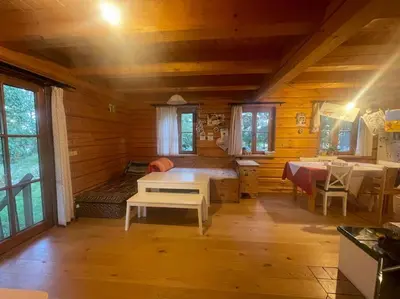 a room with a bed and a table in a cabin at Roubenka v Posázaví in Zbizuby