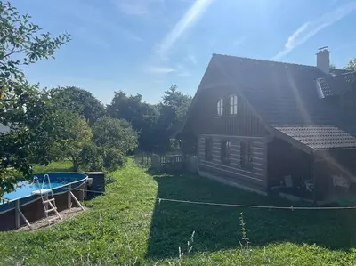 a house with a yard with a pool and a house at Roubenka v Posázaví in Zbizuby